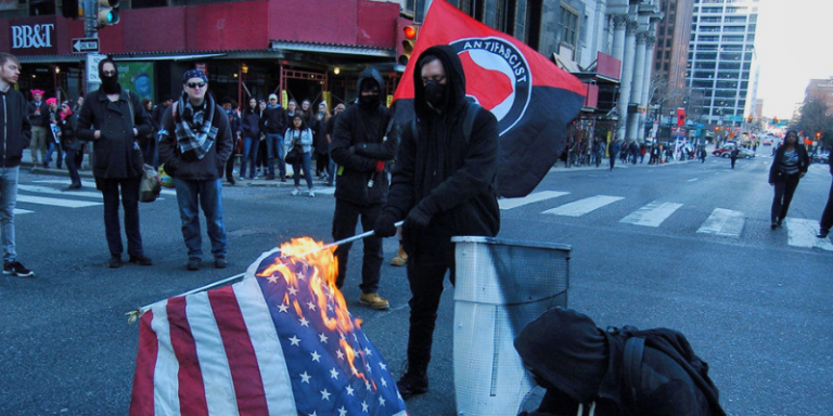 Antifa burn flag (Photo by Cory ClarkNurPhoto via Getty Images)
