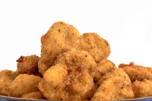 Close up of Chicken Nuggets over a white background. Healthy