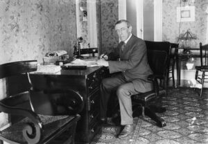 Woodrow Wilson is shown working at his desk.
